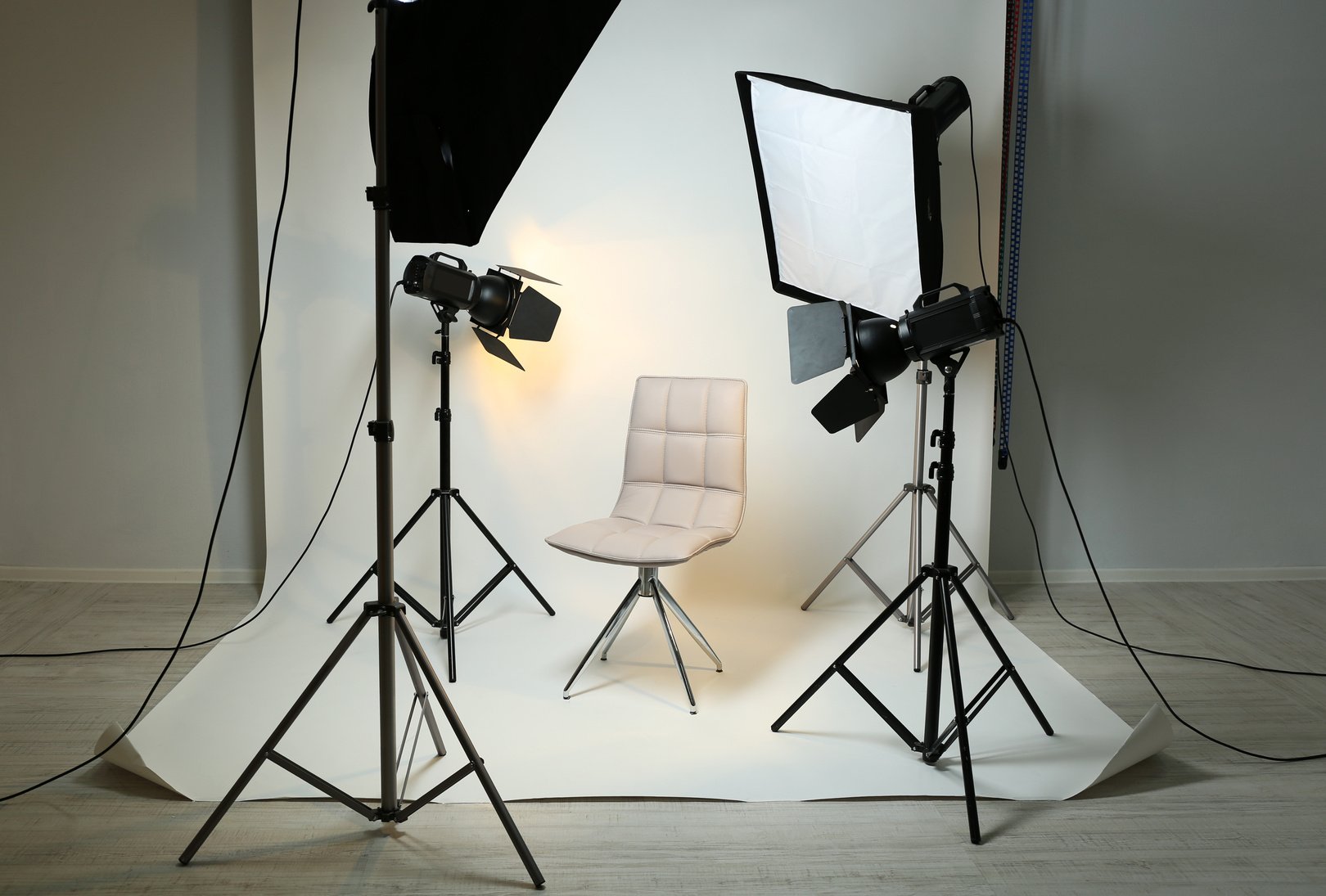 Photo Studio with Modern Chair and Lighting Equipment